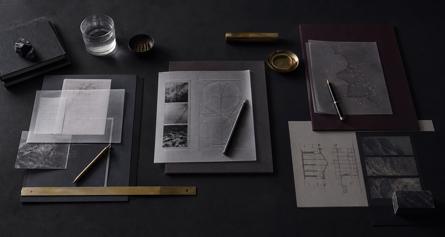 Dark architectural worktable with documents, evaluation material, and deployment planning traces